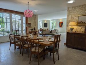 a dining room with a table and chairs at Grande maison avec piscine privée, wifi et animaux acceptés pour 15 pers. - FR-1-653-282 in Pranzac