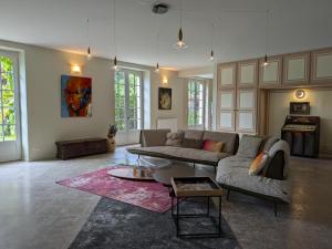 a living room with a couch and a table at Grande maison avec piscine privée, wifi et animaux acceptés pour 15 pers. - FR-1-653-282 in Pranzac