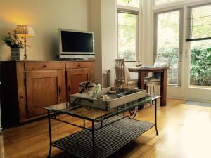 a living room with a glass table and a tv at Apartment in Zandvoort with swimming pool in Zandvoort