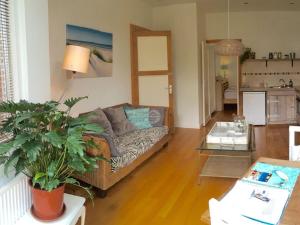 a living room with a couch and a table at Apartment in Zandvoort with swimming pool in Zandvoort