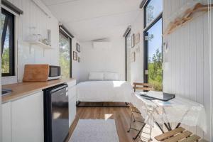 a bedroom with a bed and a desk with a laptop at Mugul Dream Cottage by Tiny Away in Colosseum
