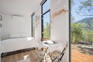 a bedroom with a bed and a table and a window at Mugul Dream Cottage by Tiny Away in Colosseum