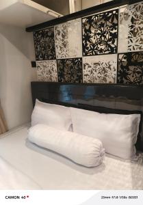 a white pillow sitting on top of a bed at CBD Studio Loft 2A at City Center! in Medan