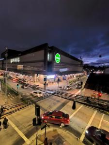 a building with a car on a city street at night at Sky Aloja Hotel - Mall Centro in Osorno +25 photos
