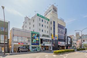 a city street with many buildings and a street sign at Mizusawa Green Hotel in Oshu
