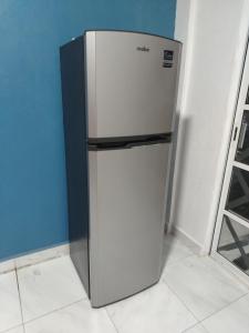 a refrigerator in the corner of a room at Casa Blanca Puerto Marqués 10 in Acapulco