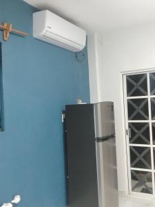 a refrigerator in a kitchen with a ceiling fan at Casa Blanca Puerto Marqués 10 in Acapulco