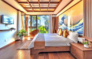 a bedroom with a large bed and a large window at S79 Residences Khai Ngoc Dalat in Da Lat