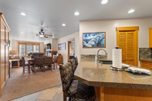 a kitchen and living room with a counter and a dining room at Springs 8845 by Summit County Mountain Retreats in Snake River Health Services Incorporated Heliport
