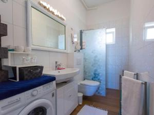 a bathroom with a washing machine and a sink at Apartment Nina in Porec, Istria in Poreč +26 photos