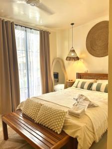 a bedroom with a bed and a large window at Lolas Villa El Nido in El Nido