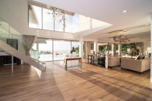 un ampio soggiorno con una grande parete di vetro di Seascape 6BR Prestige Villa Skyline Pool a Ban Nakhale Altre 213 foto