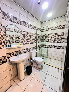a bathroom with a toilet and a sink at Pyramids Sphinx VIEW Hotel in Cairo