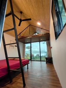a bedroom with a bunk bed and a ceiling fan at Shelby Pawana lake Cottages and Camping in Lonavala