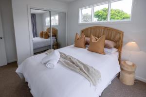 a bedroom with two beds and a mirror at Olas Villa 5 - Plunge Pool & Walk to Beach in Anna Bay +26 photos
