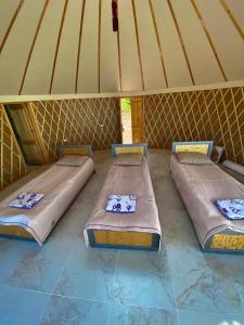 three beds sitting inside of a yurt at Casablanca Yurts in Kaji-Say