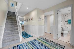 a bathroom with a staircase and a toilet at Beachy Vibes - 2BR w lake views & screened sunroom in Ponte Vedra Beach +63 photos
