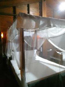 a bed with white sheets on top of it at The Cinnamon Farm Wooden Cabana Unawatuna in Unawatuna +8 photos