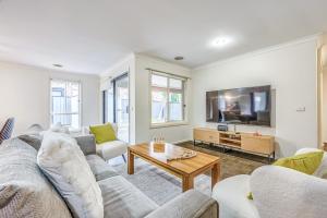 a living room with a couch and a table at StayAU Newly 8 Beds Spacious Home in Derrimut in Derrimut
