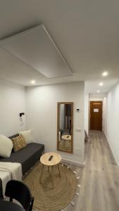 a living room with a couch and a table at Estudi Mar i Cel in Pas de la Casa