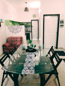 a glass table and chairs in a living room at DREAMY cosy stay 4bhk, 6 mins to Whitetown & Beach - COPPER in Puducherry +1 photo