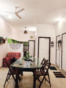 a dining room with a glass table and chairs at DREAMY cosy stay 4bhk, 6 mins to Whitetown & Beach - COPPER in Puducherry