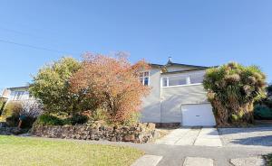 a house with a garage in a yard at StayAU 2BR Home with Stunning Views in Tasmania in Inveresk