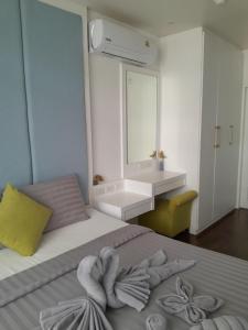a bedroom with a bed with towels on it at Arisara place in Koh Samui +8 photos