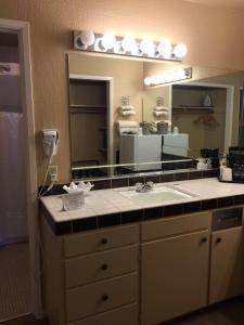 a bathroom with a sink and a large mirror at Ridgemark Golf Club and Resort in Hollister