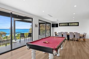 a pool table in a room with a view of the ocean at Eleve Lorne in Lorne