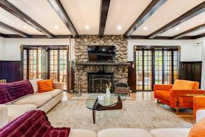 a living room with couches and a stone fireplace at Lakeview-Sleeps 12-King Suites-7BR - Firepit in Monroe