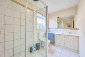a bathroom with a shower and a toilet and a sink at StayAU Family Retreat with Pool Table in Cranbourne in Cranbourne +66 photos