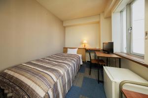 a hotel room with a bed and a desk and a window at Mizusawa Green Hotel in Oshu +33 photos