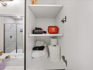 a bathroom with a sink and a toilet and a shower at Peaceful Hideaway with Pool, Gym & EV charger in Addison +21 photos