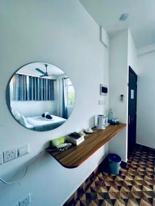 a bedroom with a large mirror on the wall at KANBULO House Maldives in Huraa