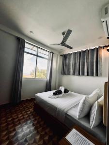 a bedroom with a large bed and a window at KANBULO House Maldives in Huraa