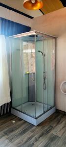 a glass shower in a bathroom with a ceiling at Uros kantuta Lodge in Puno