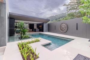 een zwembad in de achtertuin van een huis bij V253 Brand New 2BR with Pool and Full Kitchen in Thalang