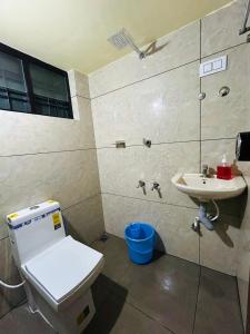 a bathroom with a toilet and a sink at Bluebell Homes in Beypore