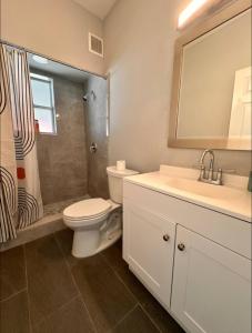 a bathroom with a toilet and a sink and a shower at Central Tampa Hot Spot! in Tampa