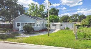 a white house on the side of a street at Central Tampa Hot Spot! in Tampa