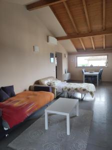 a living room with two beds and a table at La tana della Fenice in Labico
