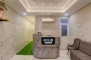 a lobby with a halo sign on the wall at Super Hotel O Maharshi Valmiki International Airport Formerly Gaurav Inn in Faizābād