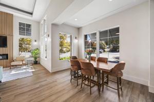 a dining room with a table and chairs at University Park Inn & Suites, an Ascend Collection Hotel in Davis
