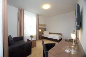 Postel nebo postele na pokoji v ubytování Hotel Brühlerhöhe