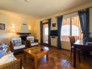 a living room with a couch and a table at Villa with Sea Breeze Charm in Cumbre del Sol +30 photos