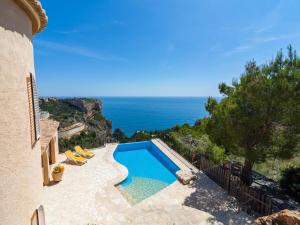 a swimming pool with a view of the ocean at Villa with Sea Breeze Charm in Cumbre del Sol