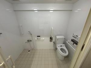 a white bathroom with a toilet and a sink at CONDOMINIUM HOTEL Riyuka in KADENA 1 in Kadena +13 photos