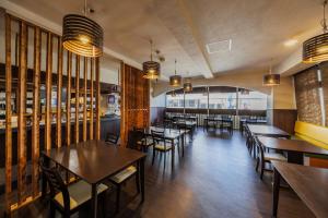 a restaurant with tables and chairs in a room at Mizusawa Green Hotel in Oshu