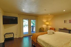 a bedroom with a bed and a large window at Lake House - Anderson Island in Anderson Island